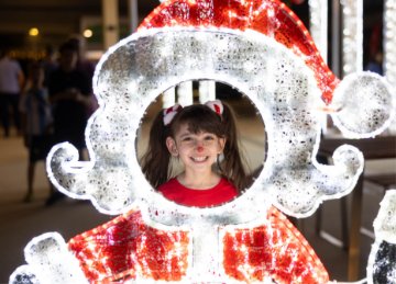Image of a two women sitting and watching the christmas lights in a giant star filled with lights